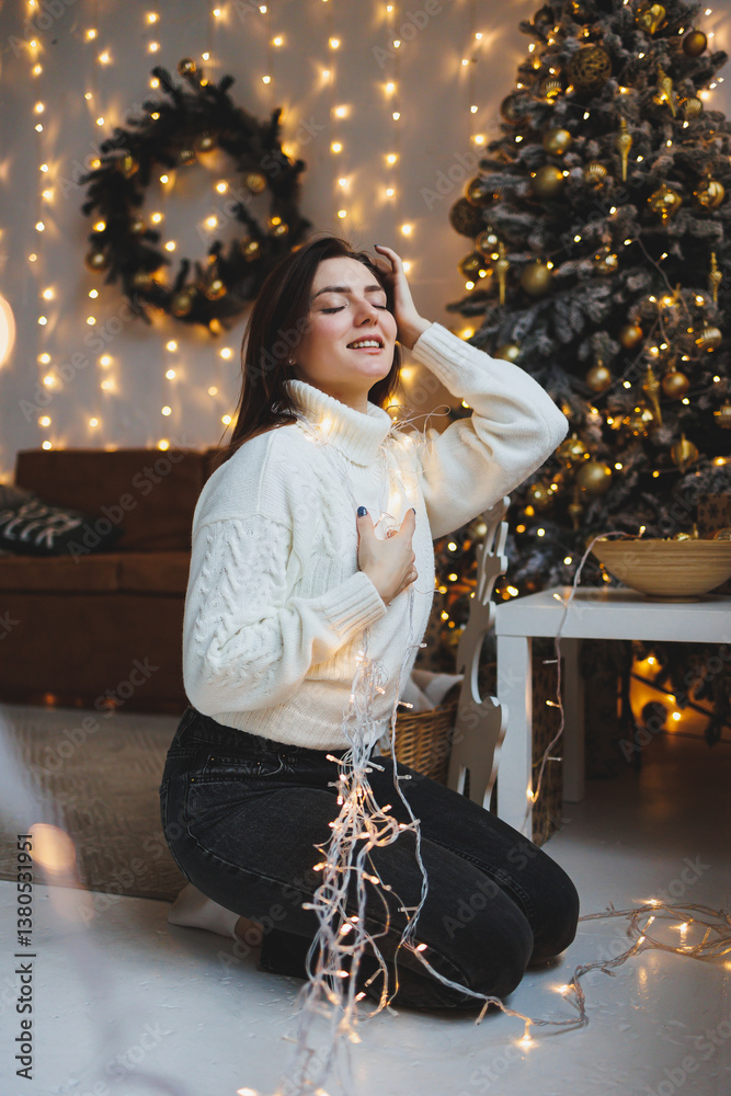 Cute girl in New Year's locations in a cozy living room. Woman at home for the new year.
