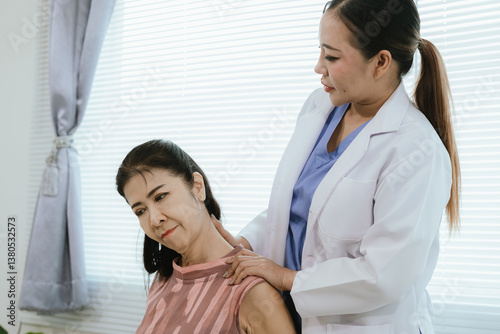 Wallpaper Mural A female physician provides care and assistance to elderly patients during medical consultations, focusing on physical therapy and recovery from conditions such as arthritis. Torontodigital.ca