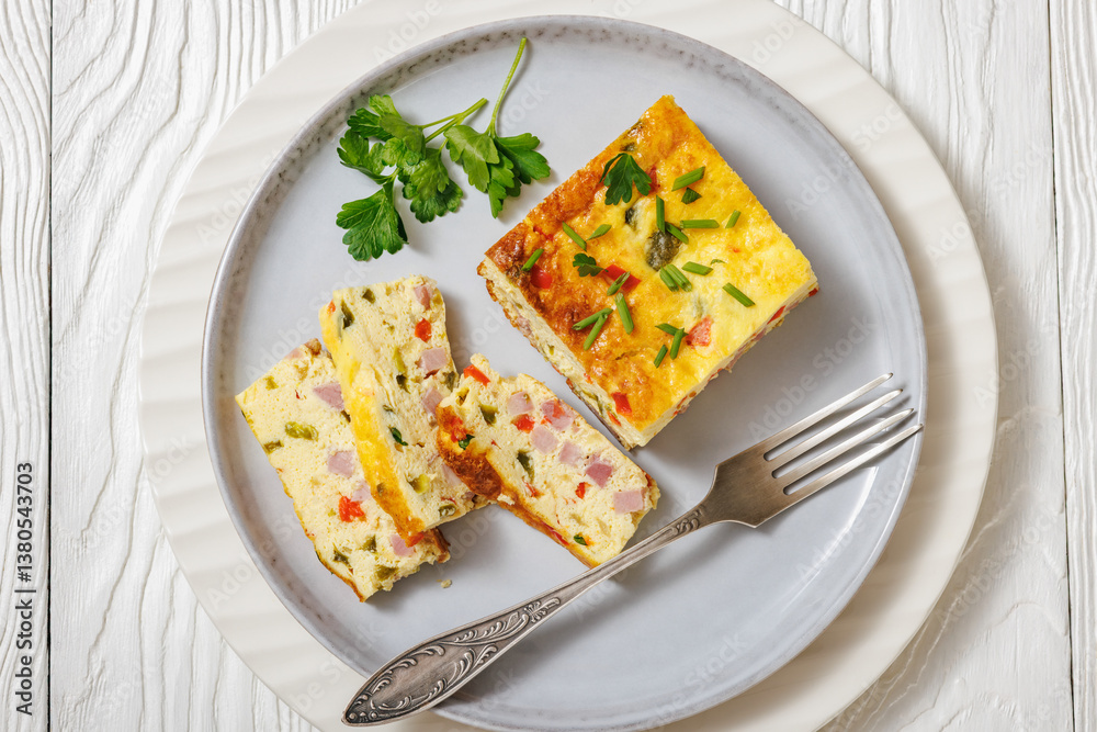 Baked Denver Omelette on a plate with fork Baked Denver Omelette on a plate with fork