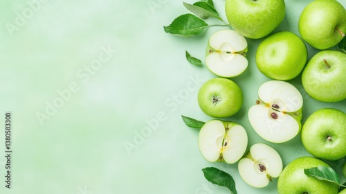 Wallpaper Mural Crisp Green Apples: Freshly picked, vibrant green apples, some sliced to reveal their juicy interiors, scattered on a verdant backdrop, creating a visually appealing display Torontodigital.ca