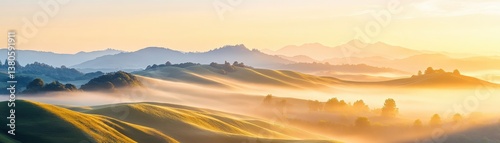 Stunning Misty Mountain Landscape at Sunset with Glowing Golden Sky and Rolling Hills