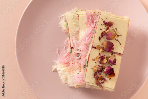Obraz na płótnie Trendy delicate white, pink chocolate with layer of white and pink pismaniye on pink background. Tasty dessert with Cotton candy. Close up. View from above. w salonie