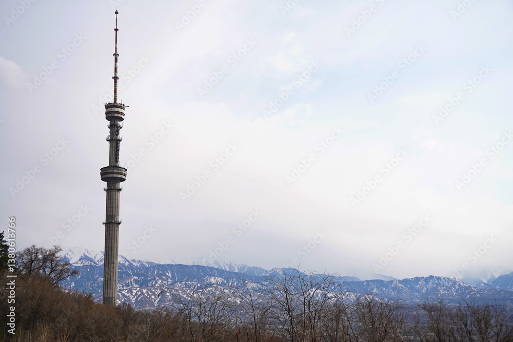 Obraz premium Kok Tobe TV tower on a hill with different vegetation. Early spring.