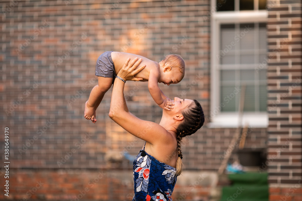 Obraz premium Joyful Moment Between Mother and Baby Outdoors