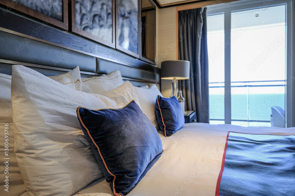 Luxurious ocean view or oceanview or outside balcony veranda cabin stateroom suite queen king double bed on luxury ocean liner cruiseship cruise ship in classic classy interior Art Deco style design