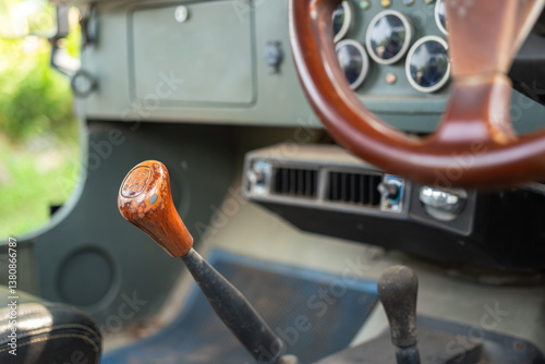 Classic car gearing lever with wooden head handle. Transportation equipment object, close-up and selective focus.