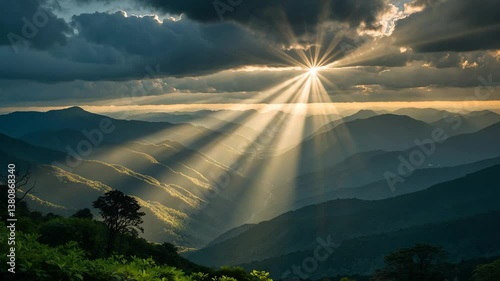 Dramatic lights shining through clouds and illuminating mountain ranges. Warm light cascade. Concept of hope and dreams.