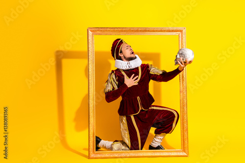 Portrait of a man in historical noble attire performing theatrically with a skull against a vibrant yellow background photo