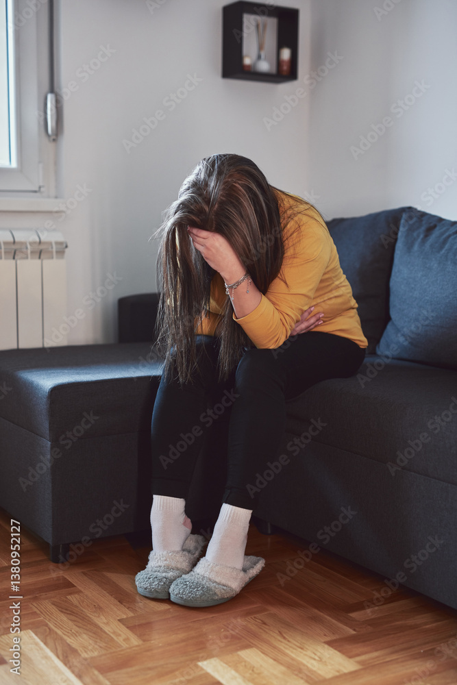 Woman with strong stomach ache, menstrual and digestive issues at home.