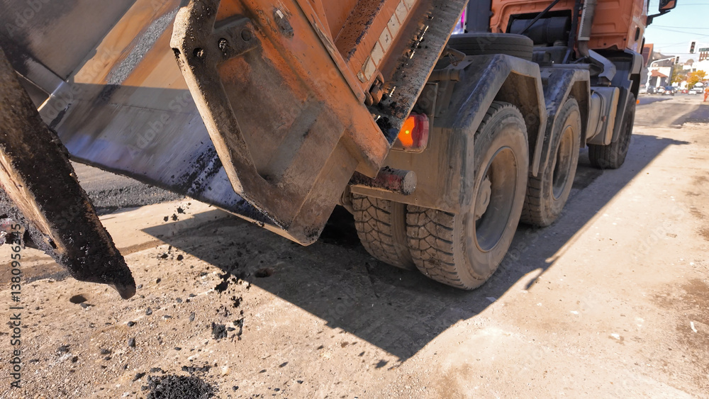 Heavy construction machines and truck outdoors for public street works.