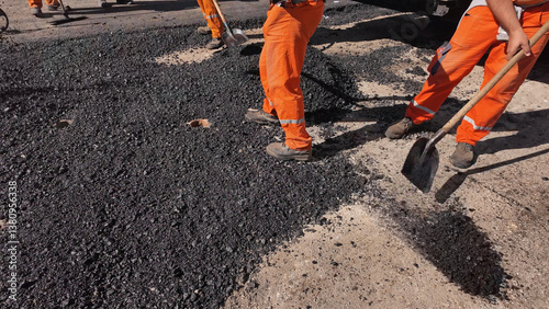 Obraz na płótnie Construction workers working on a new asphalt layer on a public street. w salonie