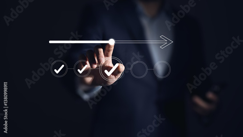 Photos Businessman touches a digital progress checklist with check marks and an advancing loading bar, symbolizing task completion and project progress