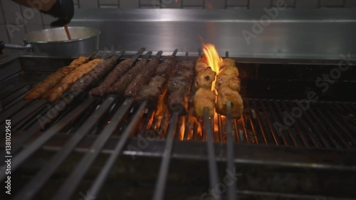 Grilling delicious kebabs over open flames food preparation area culinary art vibrant kitchen environment close-up perspective flavorful cooking concept