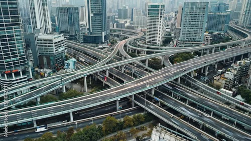 Urban Highway Interchange: A sprawling network of elevated roadways and overpasses converges amidst a cityscape of modern skyscrapers.