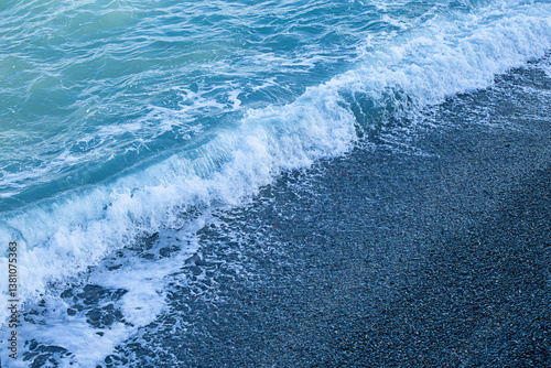 Fototapeta Naklejka Na Ścianę i Meble -  Seashore, pebbles and a small wave