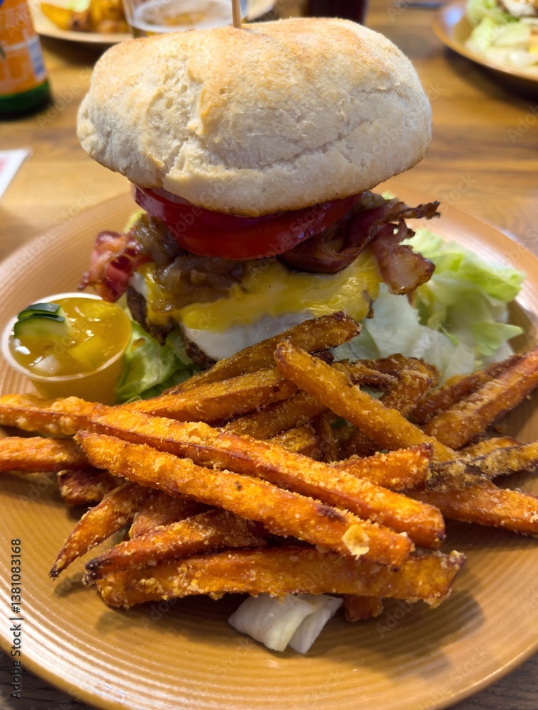 homemade cheeseburger with bacon and sweet potato fries and dip