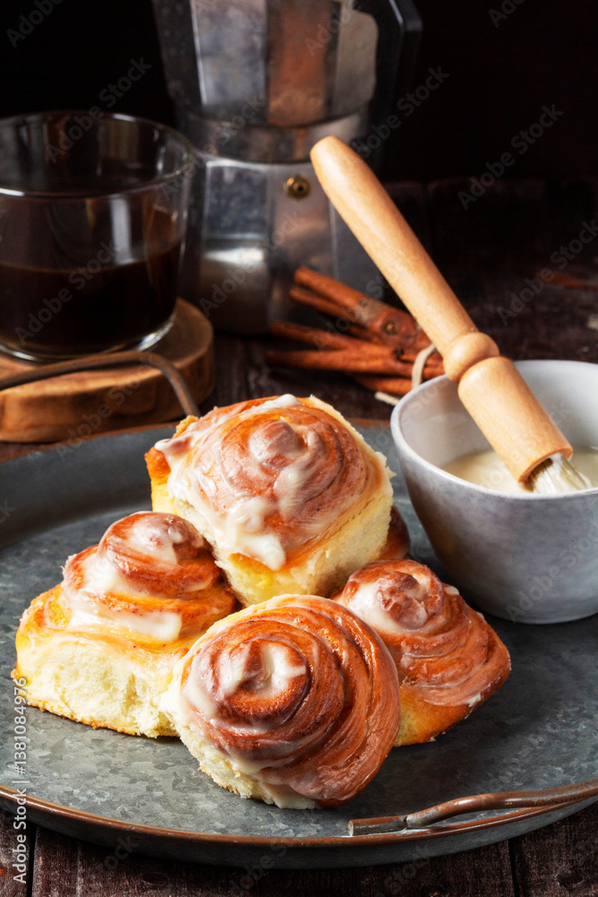 Cinnabons, cinnamon rolls topped with a cream of cream, cheese and sugar.
