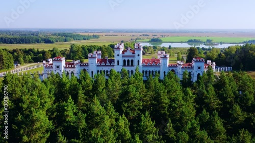 The Puslovsky Palace in Belarus. The Kossovsky Autumn Castle. An old historical castle in the style of English Gothic Revival in Kosovki in sunny autumn weather.Top view.Drone.4K photo