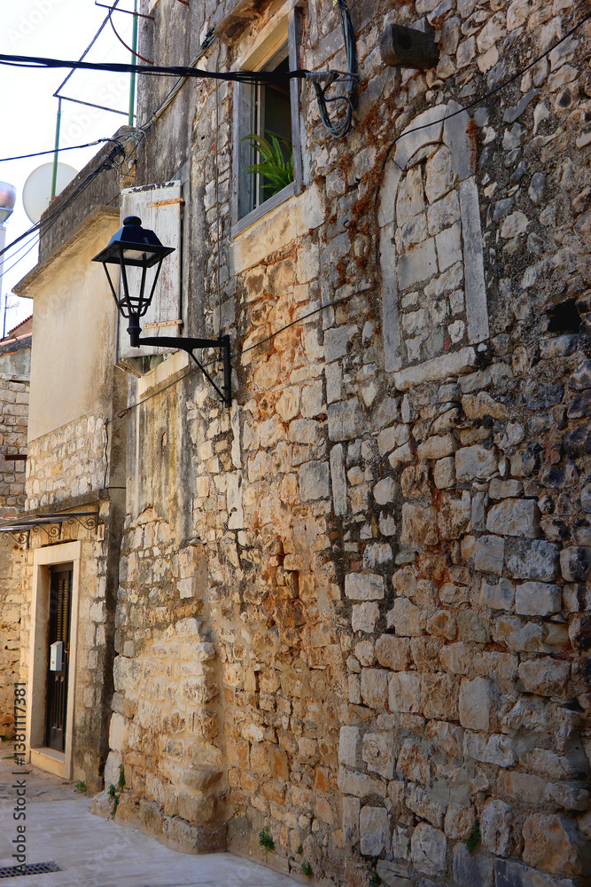 Picturesque Mediterranean street and traditional architectural details in Trogir, Croatia.