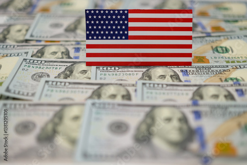 American flag with us dollars. American trade policy. Tariff regime. Blurred background. Shallow depth of field. Copy space. photo