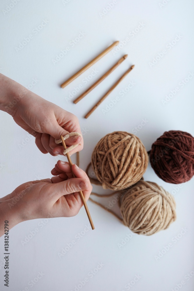 female hand knitting wool with needles on a light background female hand knitting wool with needles on a light background