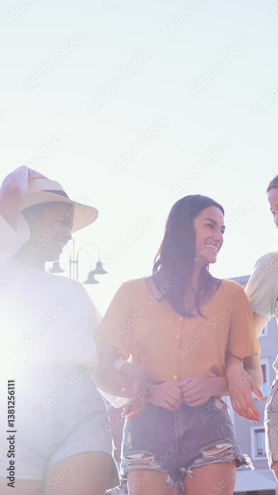Vertical. Three cheerful young women tourists enjoying their vacation, together while holding hands in a bustling town square on a sunny summer day, radiating joy and friendship Vertical. Three cheerful young women tourists enjoying their vacation, together while holding hands in a bustling town square on a sunny summer day, radiating joy and friendship