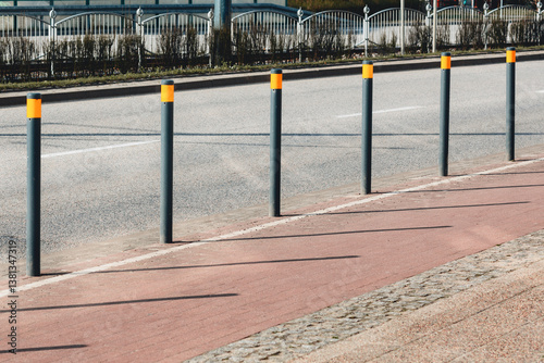 Street bollards on a sidewalk protecting pedestrian zone from traffic