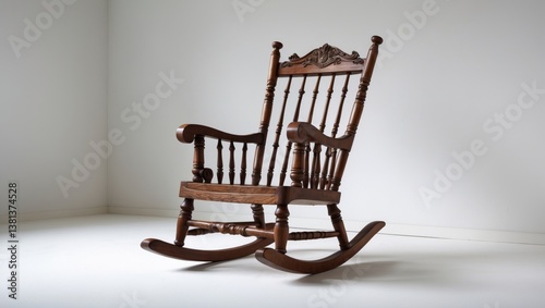 Old wooden rocking chair on a light backdrop.