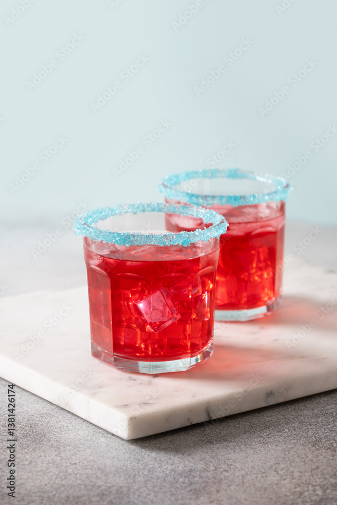 Independence Day of July 4th. Celebratory red margarita in glasses on gray background. Vertical format. Close up.