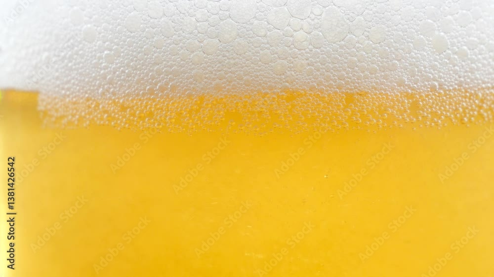 Light hoppy beer, foaming and sparkling in a beer glass. Close-up. Slow motion. Light hoppy beer, foaming and sparkling in a beer glass. Close-up. Slow motion.