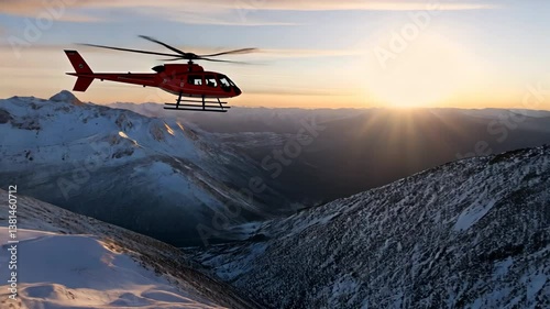 A red helicopter is flying over a snowy mountain range. The sky is clear and the sun is shining brightly.