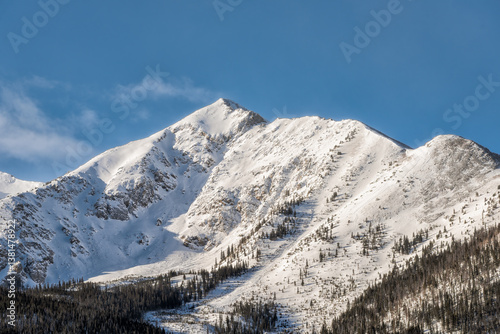 Frisco, Colorado snow capped rocky mountains peak one closeup in winter weather sunrise sunlight and blue sky landscape