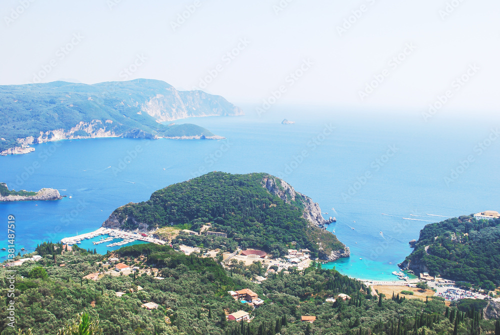 Naklejka premium Mediterranean coastal landscape in Greece with green hills, turquoise sea bays and marina, aerial view of a scenic summer destination in Europe, concept travel, nature, relaxation