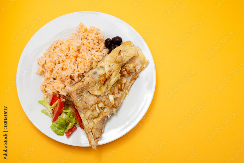 Fried cod fish with onion, pepper and boiled rice on dish Fried cod fish with onion, pepper and boiled rice on dish