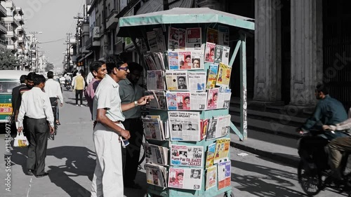 Man browsing newspapers at a newsstand in delhi