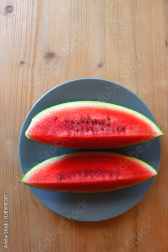 Obraz na płótnie Plate with two watermelon slices on the table. Top view. w salonie