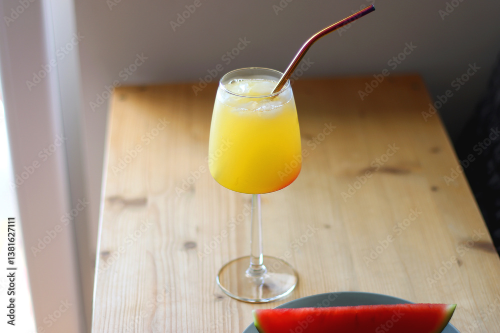 Plate with two watermelon slices and glass of orange juice on the table. Selective focus.