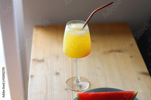 Obraz na płótnie Plate with two watermelon slices and glass of orange juice on the table. Selective focus. w salonie