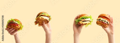 Cuadro en lienzo Female hands with tasty burgers on light yellow background
