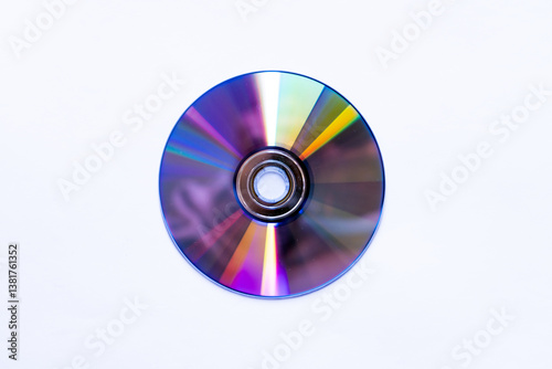 Top view of a compact disc with rainbow reflections on white background. 