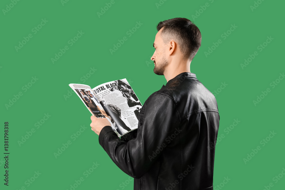Handsome man reading magazine on green background, back view