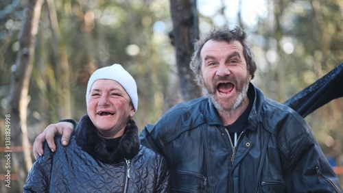 Tableau sur toile Intoxicated homeless pair grinning, revealing toothless grins amid snowy woodlan