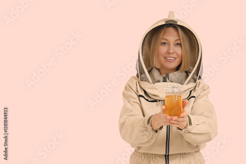 Female beekeeper with jar o...