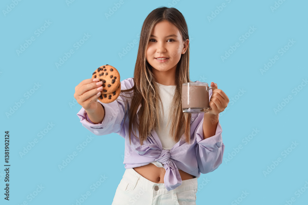 Cute teenage girl with delicious cookies and cup of hot chocolate on blue background