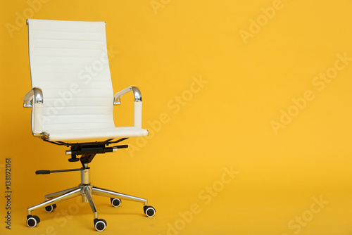 Modern office chair on yellow background. Space for text