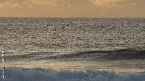 Young surfer silhouette sitting on his surfboard in the ocean water at sunrise. beautiful seascape at morning time.Maldives