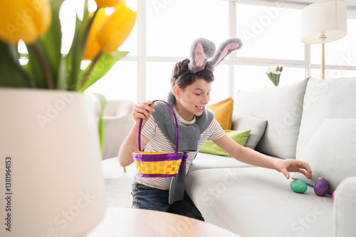 Teenage boy in bunny ears w...