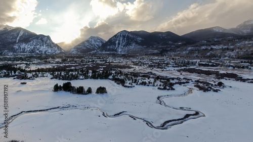 Aerial view of the snow covered mountains and town of Dillon, Colorado, USA. The Snake River winds through the frozen landscape. Winter scene.