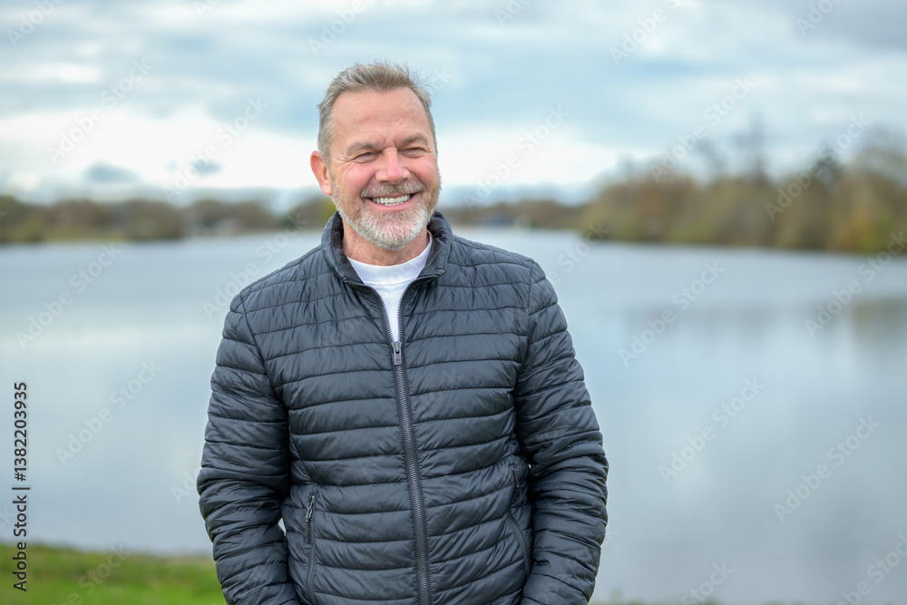 Man Laughing Beside Peaceful Lake