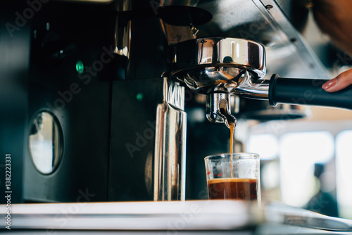 At cafe shop coffee pours from espresso machine. Modern technology showcased with liquid flowing into glasses. Smooth service transparent cups displaying the coffee making process.